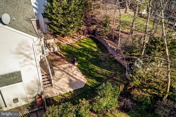 an aerial view of a house with garden space and street view