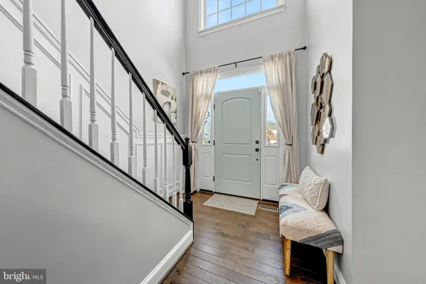 a hallway with stairs and a couch