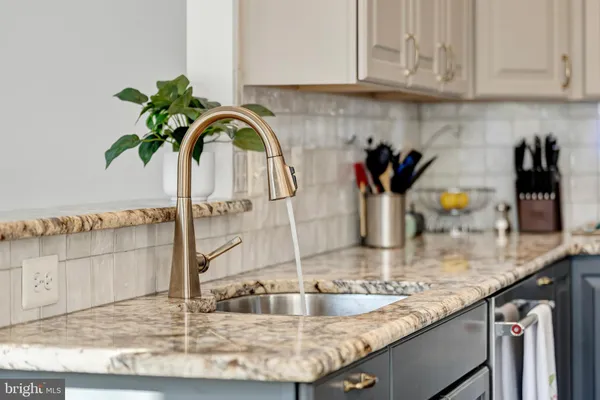 a kitchen with a sink and a white cabinets