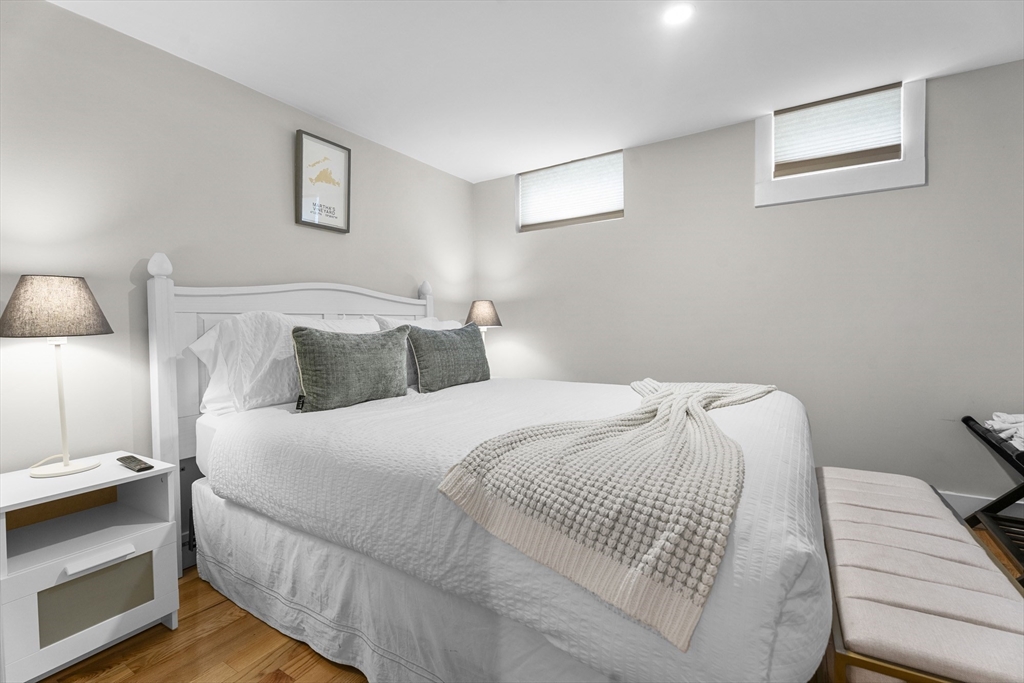 4 Hye Lane Edgartown, MA 02539 - Photo 15 of 41 a bedroom with a bed and a night stand