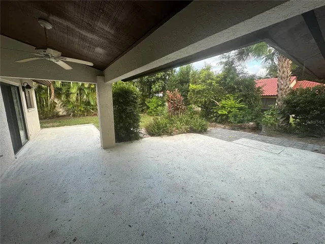 a view of a porch with furniture and a yard