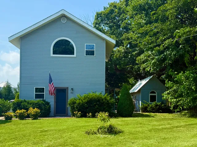 a front view of house with yard and green space