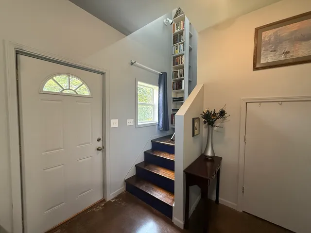 a view of entryway with stairs and wooden floor