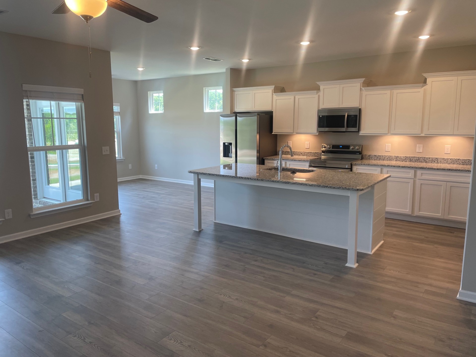 414 Wren Way Spring Hill, TN 37174 - Photo 3 of 12 a large kitchen with stainless steel appliances granite countertop a stove and a wooden floors