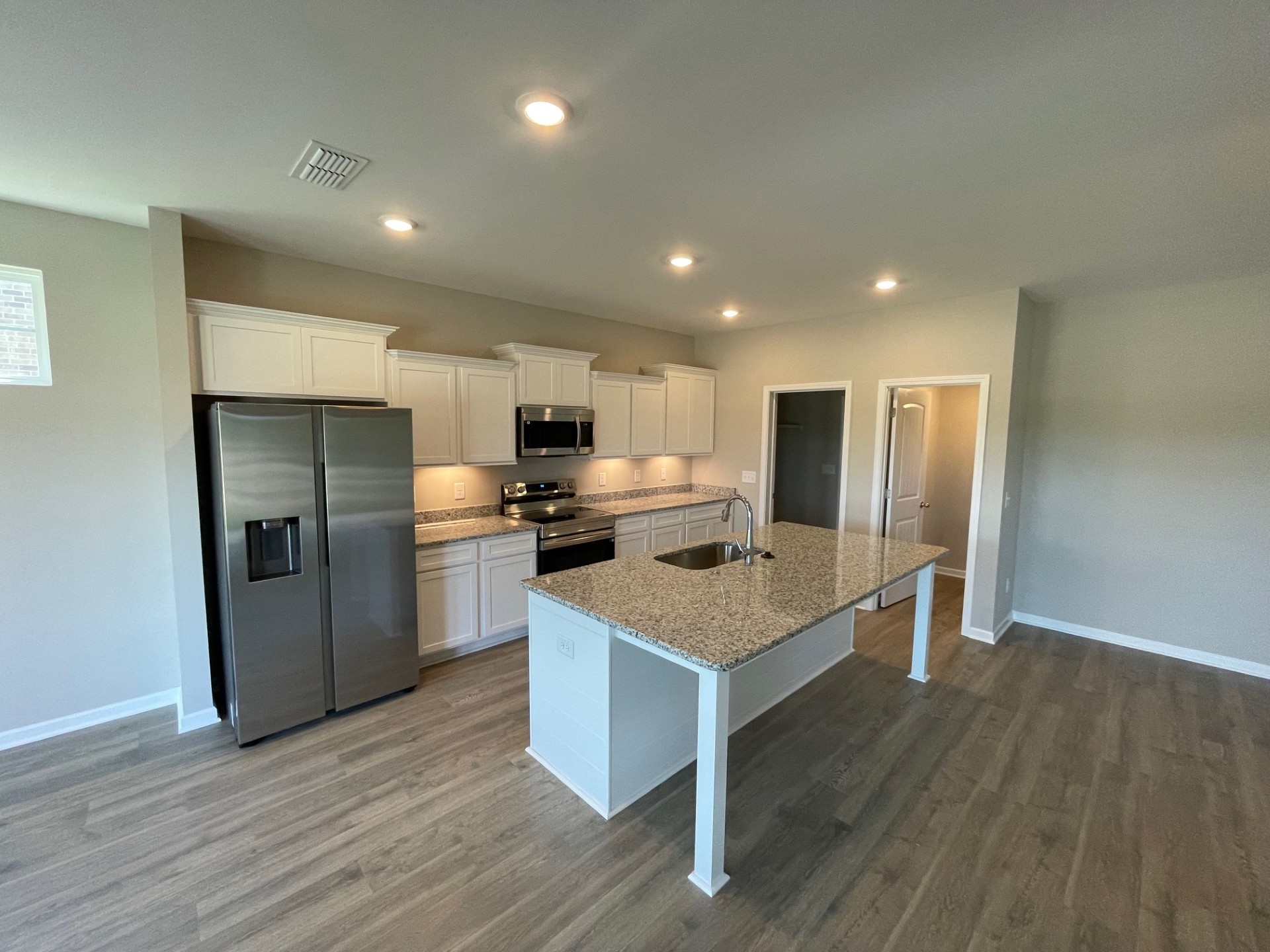 414 Wren Way Spring Hill, TN 37174 - Photo 5 of 12 a kitchen with stainless steel appliances granite countertop a refrigerator a sink dishwasher a stove and a refrigerator