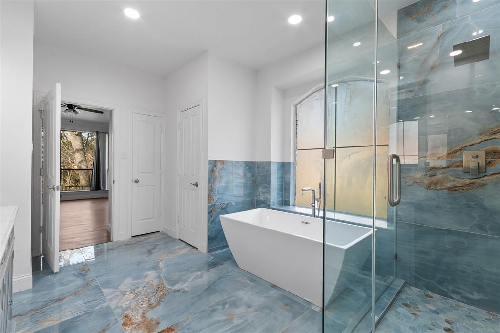 225 Freedom Court Rockwall, TX 75032 - Photo 16 of 28 a bathroom with a tub and shower
