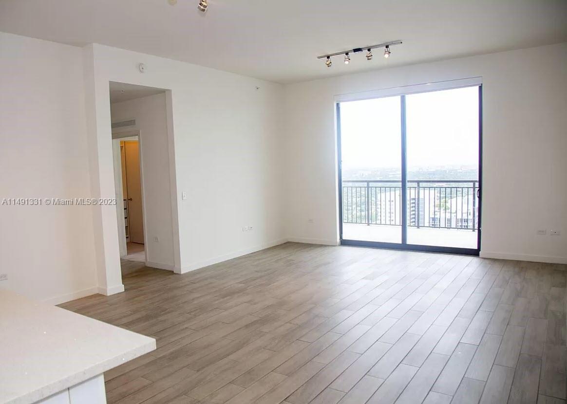 Brickell Miami, FL 33130 - Photo 11 of 20 an empty room with wooden floor and windows