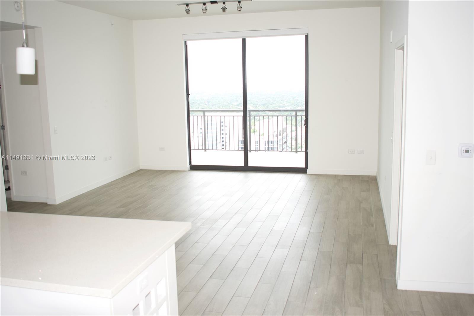 Brickell Miami, FL 33130 - Photo 15 of 20 a view of a room with wooden floor and a window