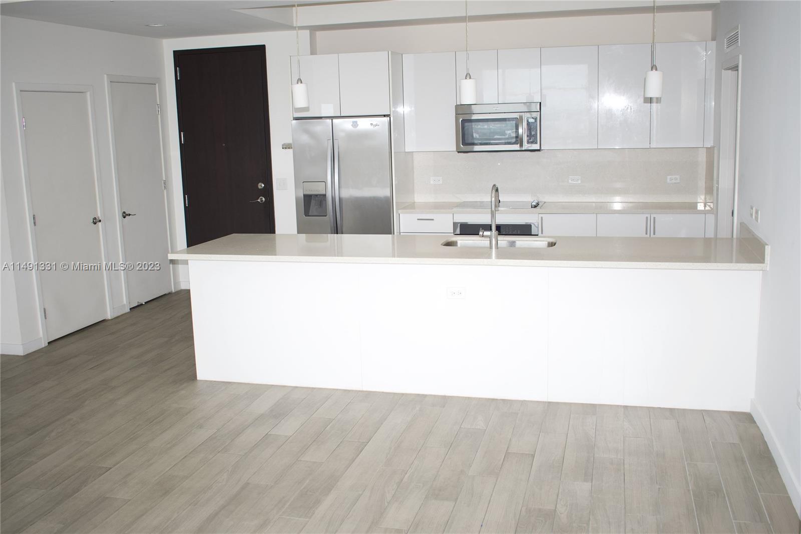 Brickell Miami, FL 33130 - Photo 16 of 20 a large kitchen with stainless steel appliances a refrigerator and a sink