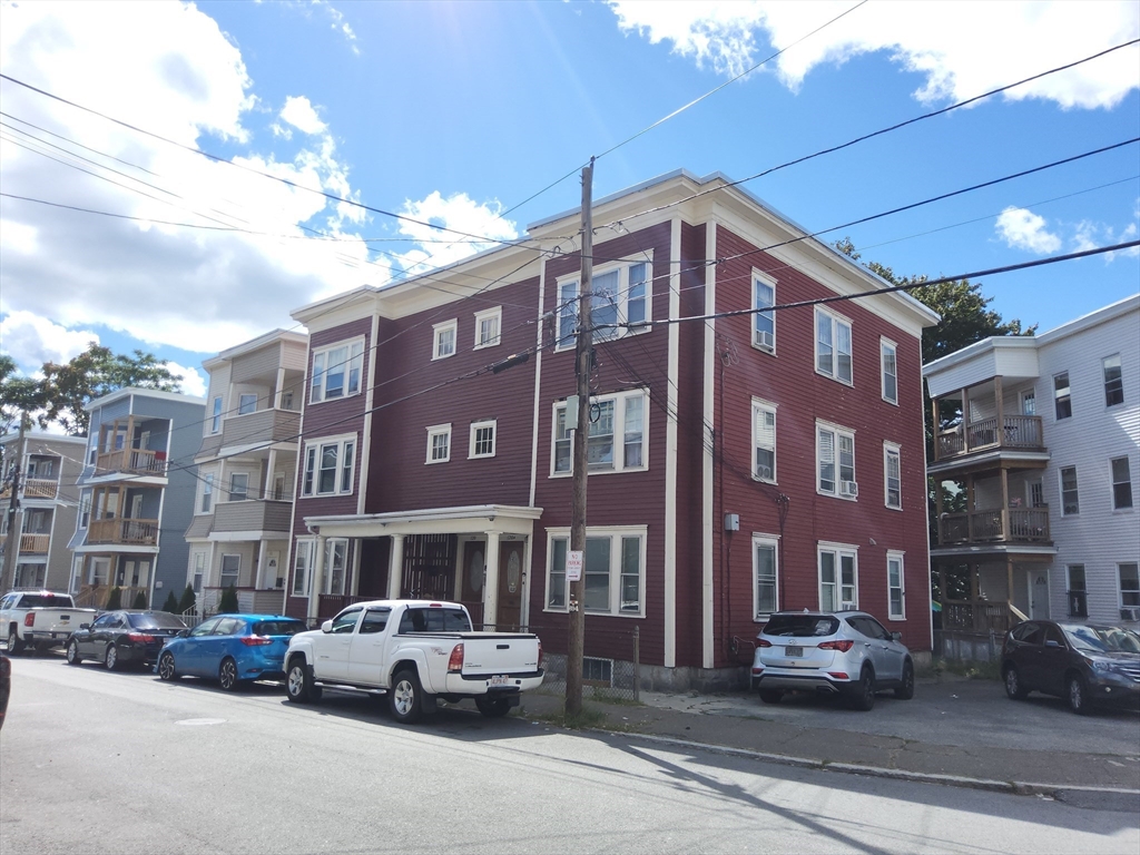 116 Bennington Street Lawrence, MA 01841 - Photo 2 of 14 a car parked in front of a building