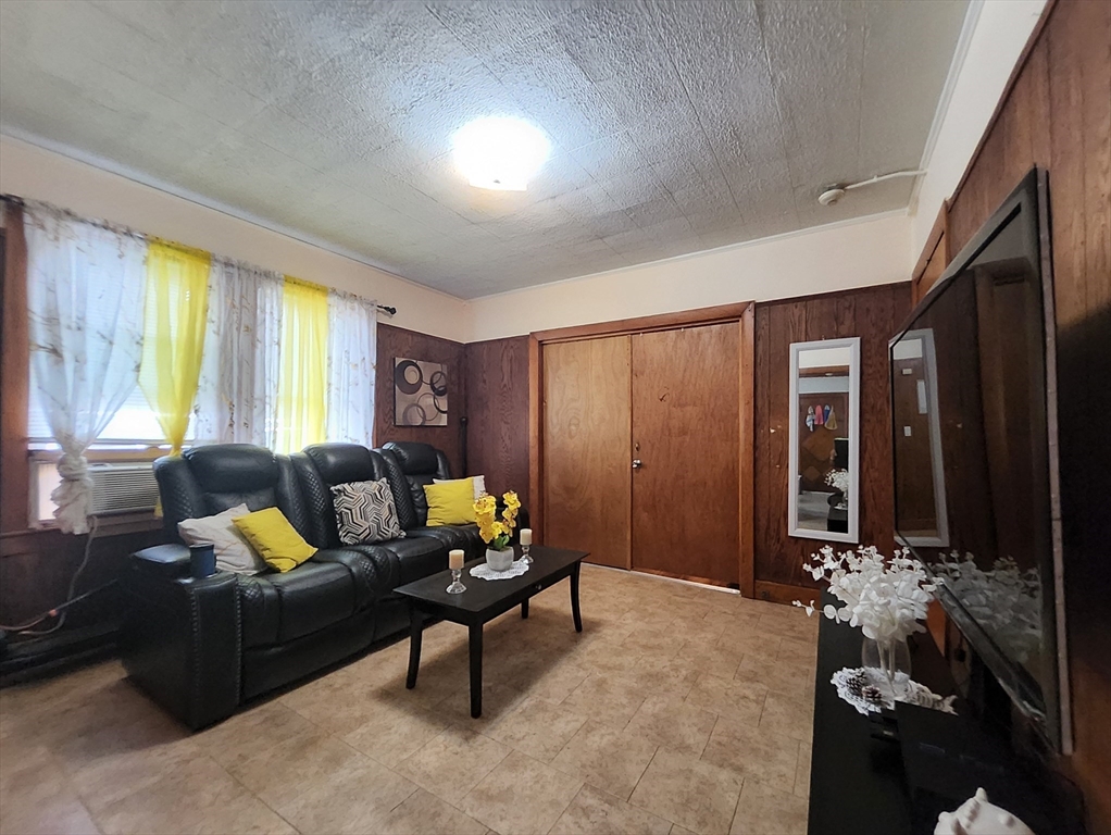 116 Bennington Street Lawrence, MA 01841 - Photo 6 of 14 a living room with furniture and a large window