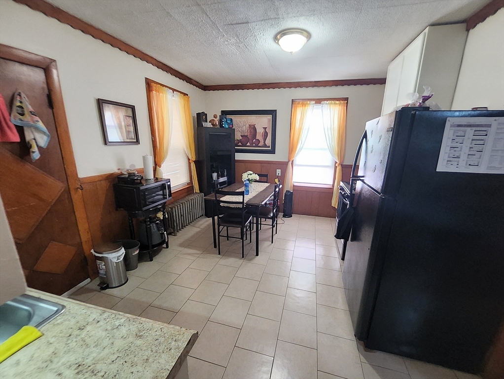 116 Bennington Street Lawrence, MA 01841 - Photo 8 of 14 a workspace with furniture and a window