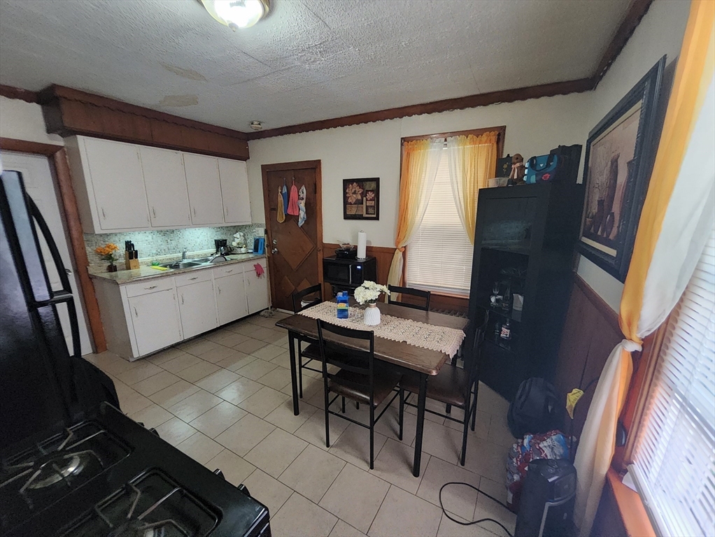 116 Bennington Street Lawrence, MA 01841 - Photo 9 of 14 a workspace with furniture and window