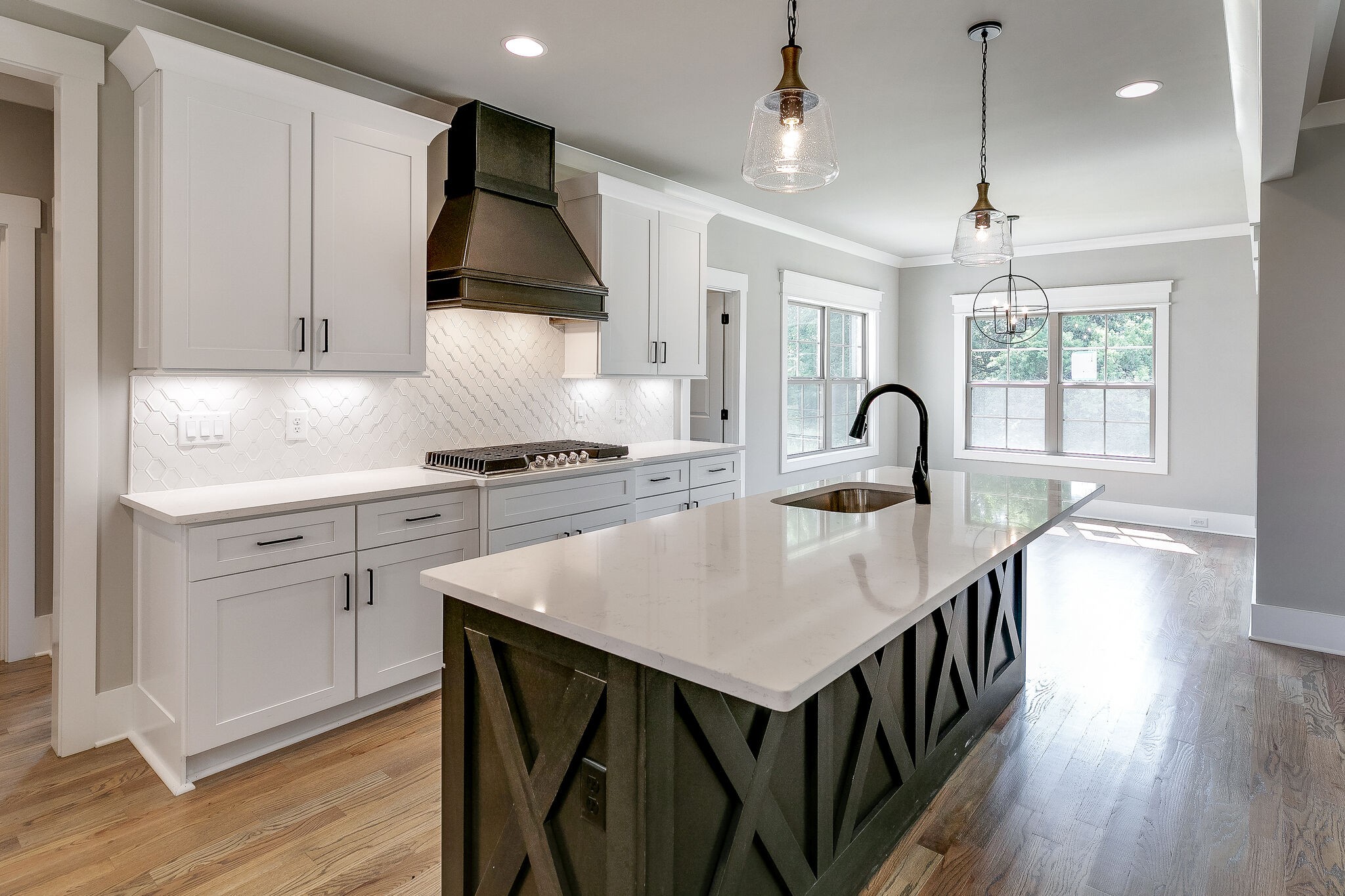 108 Arkstone Ln Spring Hill Spring Hill, TN 37174 - Photo 12 of 37 a kitchen with kitchen island a stove a sink a center island and wooden floor
