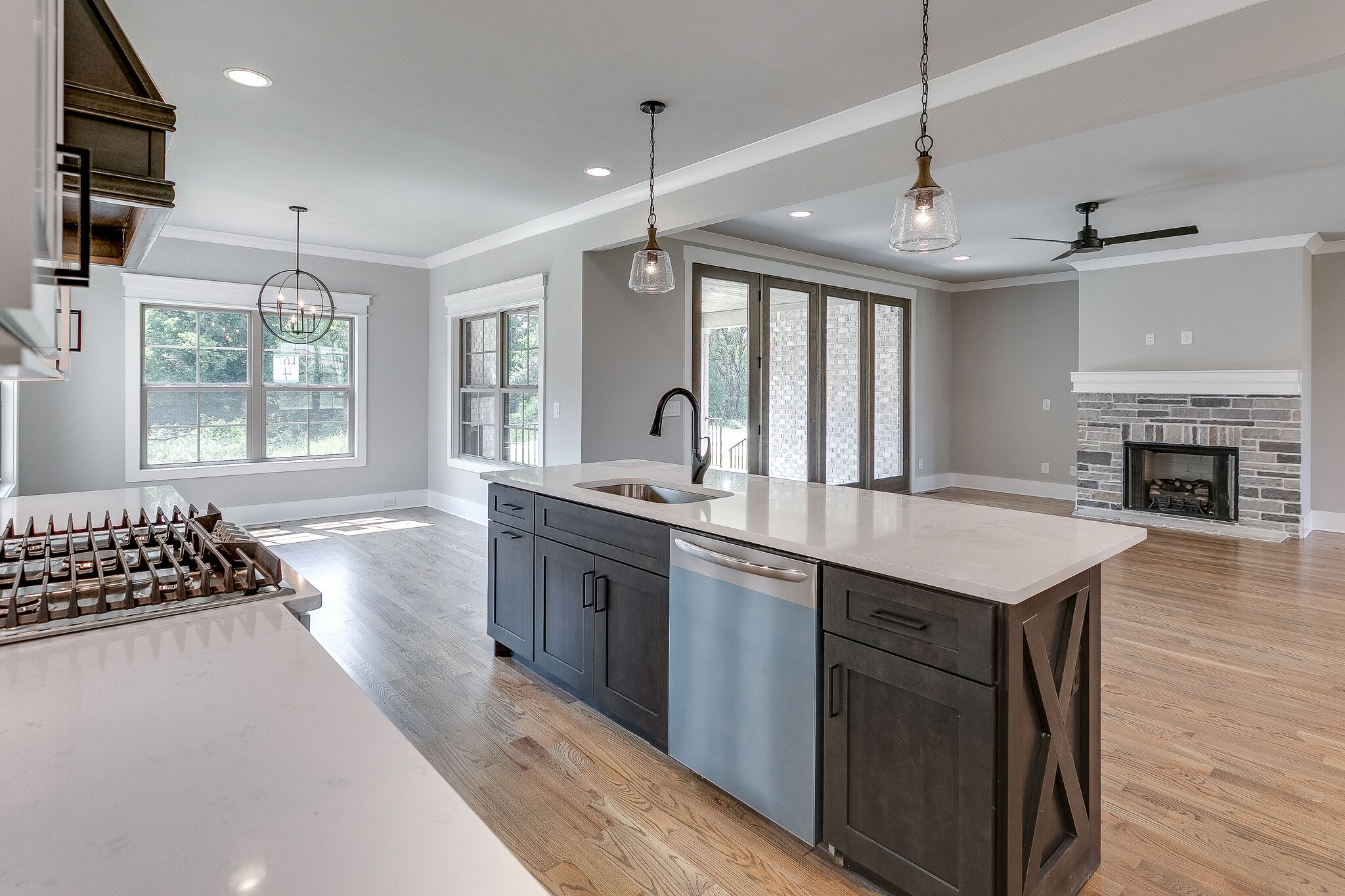 108 Arkstone Ln Spring Hill Spring Hill, TN 37174 - Photo 14 of 37 a kitchen with stainless steel appliances granite countertop a stove a sink dishwasher a refrigerator and a dining table with wooden floor