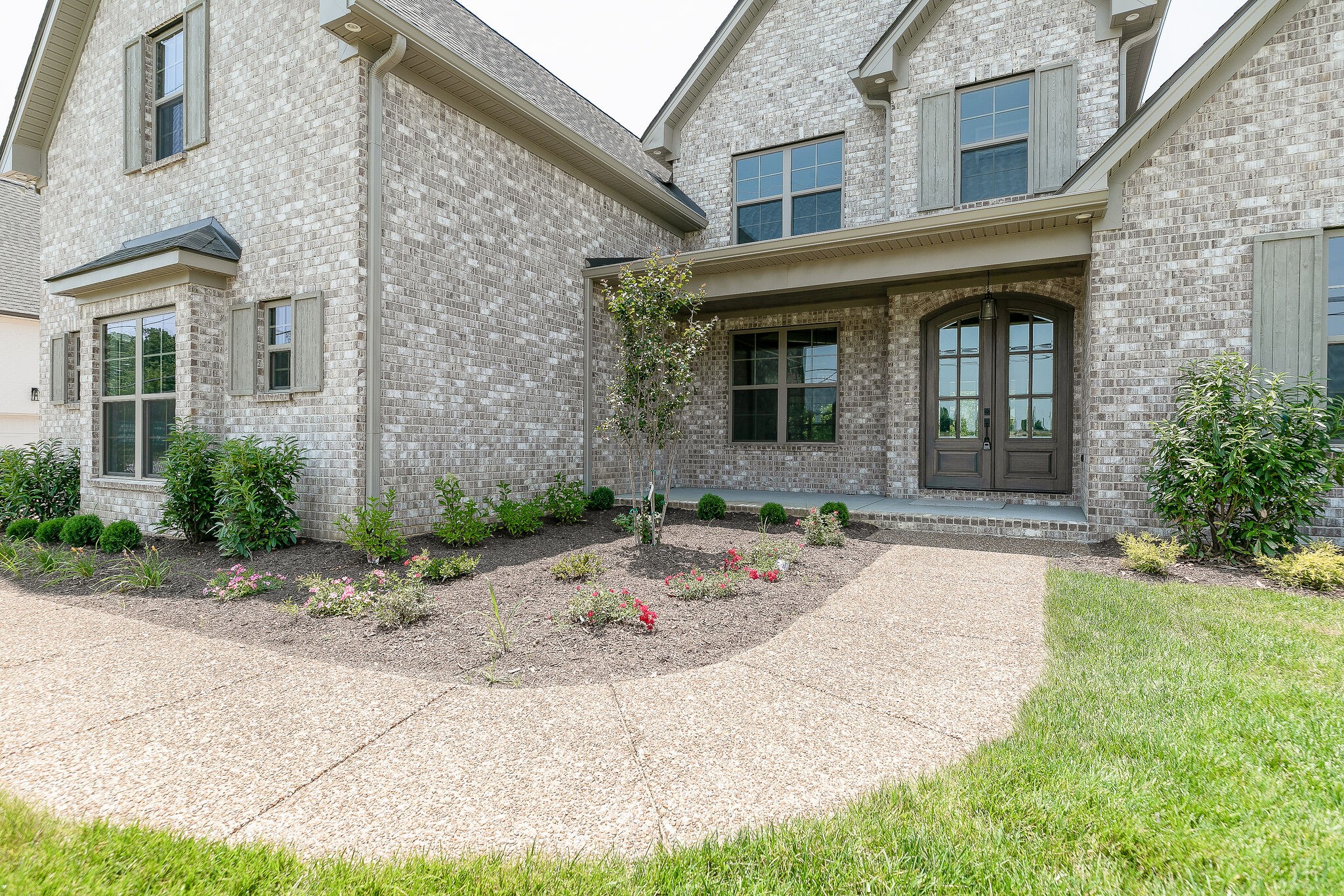 108 Arkstone Ln Spring Hill Spring Hill, TN 37174 - Photo 2 of 37 a front view of a brick house with a yard
