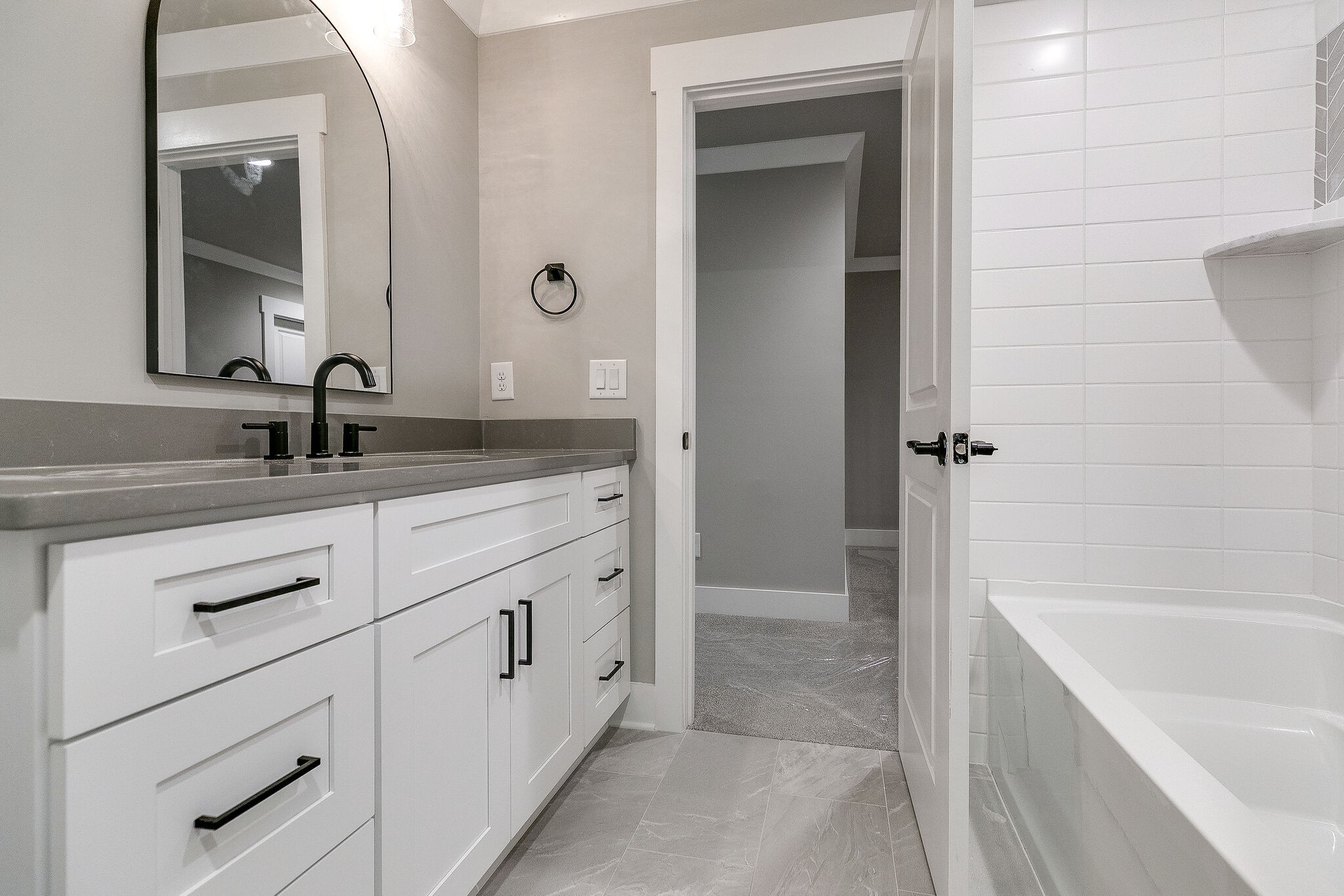 108 Arkstone Ln Spring Hill Spring Hill, TN 37174 - Photo 27 of 37 a bathroom with a double vanity sink a mirror and a bathtub