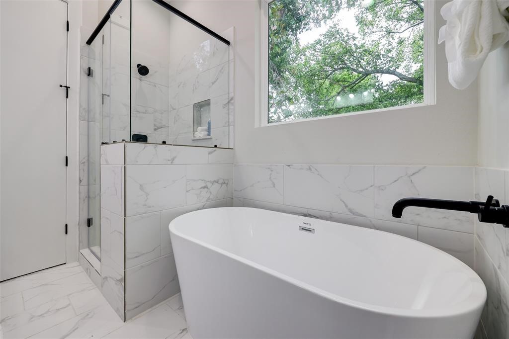 846 Elkhart Street, Unit E Houston, TX 77091 - Photo 13 of 24 a white bath tub sitting in a bathroom