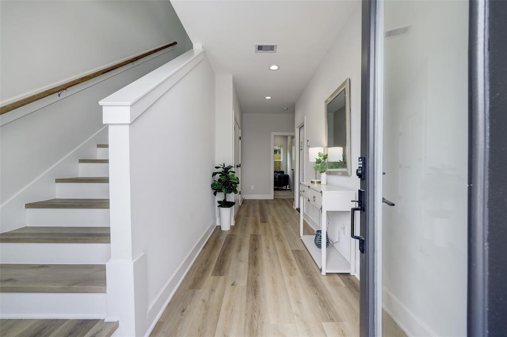 846 Elkhart Street, Unit E Houston, TX 77091 - Photo 15 of 24 a view of a hallway with wooden floor and staircase