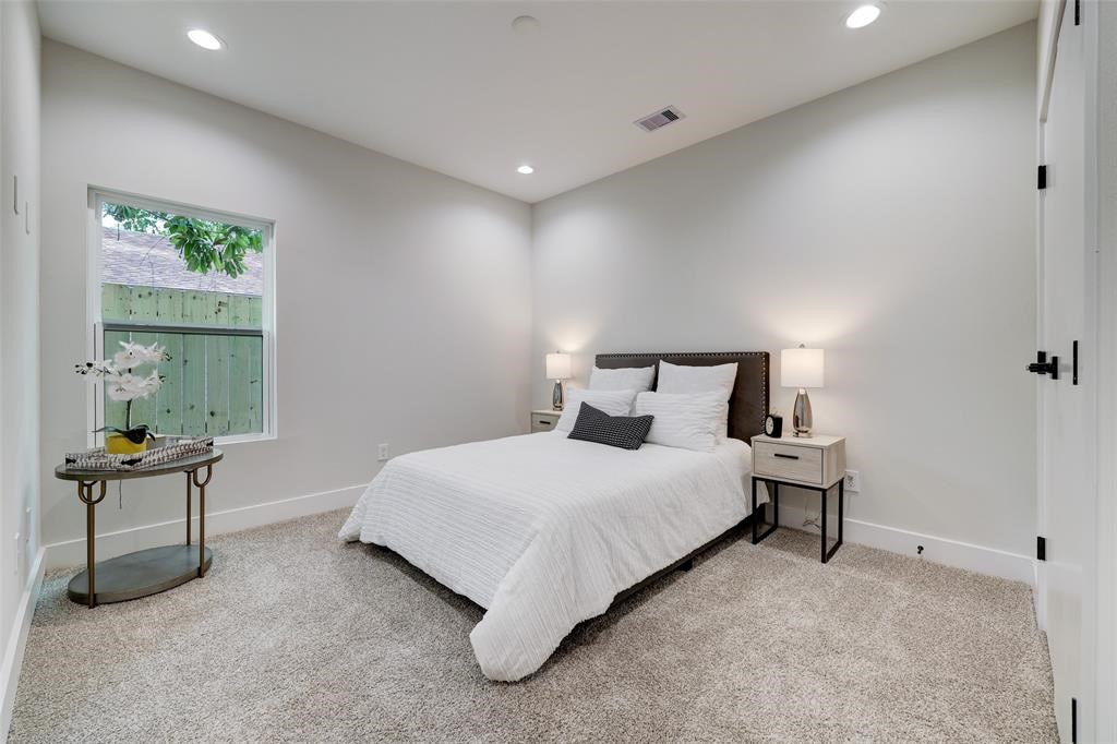 846 Elkhart Street, Unit E Houston, TX 77091 - Photo 18 of 24 a bedroom with a bed and chair