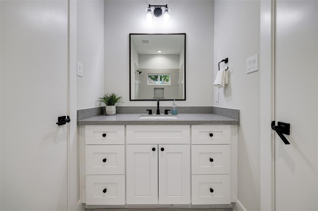846 Elkhart Street, Unit E Houston, TX 77091 - Photo 19 of 24 a bathroom with a sink vanity and mirror