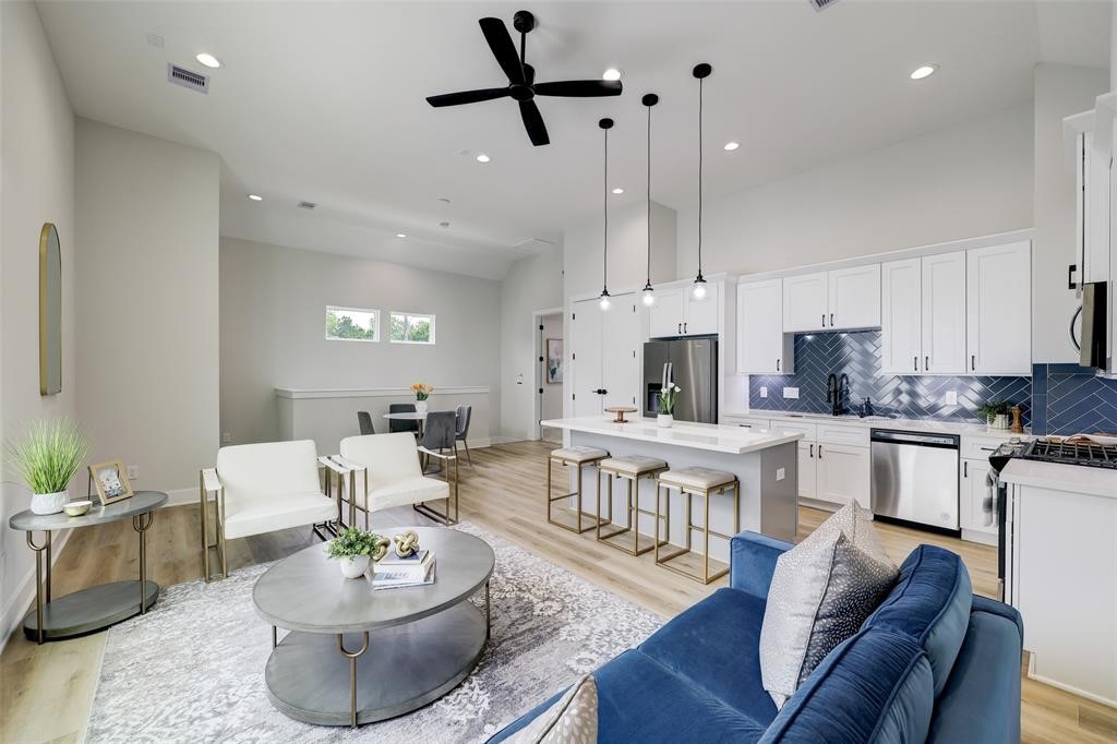 846 Elkhart Street, Unit E Houston, TX 77091 - Photo 2 of 24 a living room with furniture kitchen view and a wooden floor