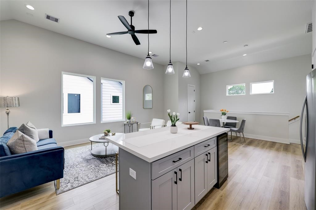 846 Elkhart Street, Unit E Houston, TX 77091 - Photo 5 of 24 a bathroom with a sink a chandelier and wooden floor