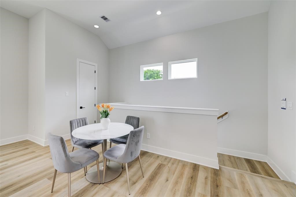 846 Elkhart Street, Unit E Houston, TX 77091 - Photo 8 of 24 a view of a dining room with furniture and wooden floor
