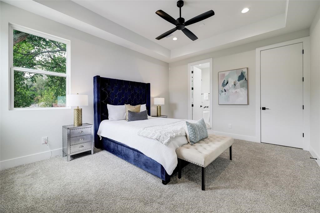 846 Elkhart Street, Unit E Houston, TX 77091 - Photo 10 of 24 a bedroom with a bed and a painting on the wall