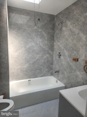 a bathroom with a bathtub and a sink