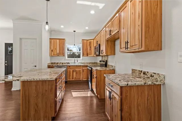 an empty room with a window and wooden floor