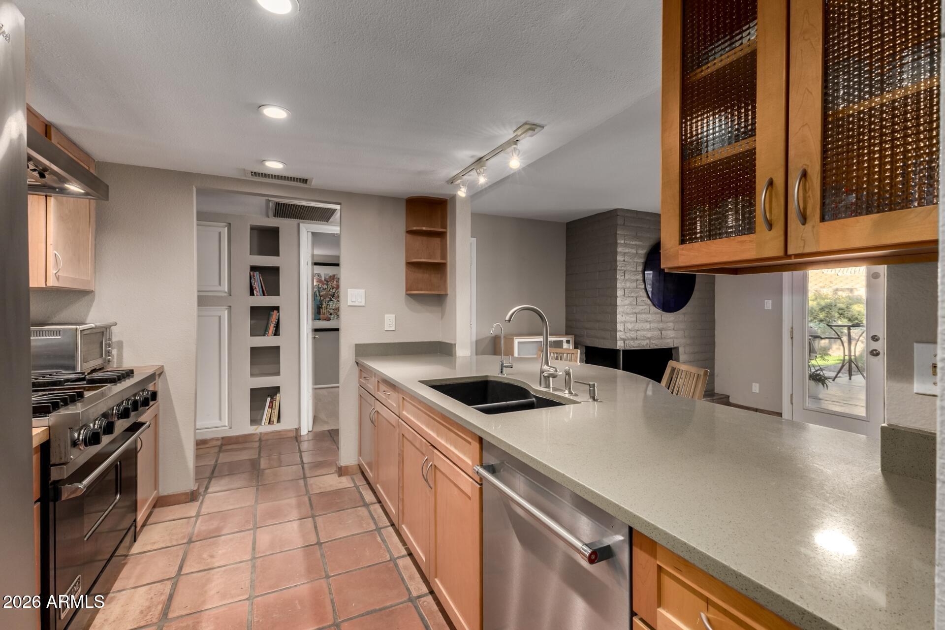 7657 North 22nd Street Phoenix, AZ 85020 - Photo 18 of 76 a kitchen with stainless steel appliances granite countertop a sink and a stove