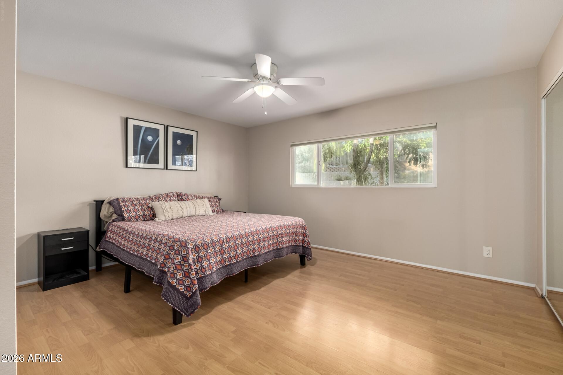 7657 North 22nd Street Phoenix, AZ 85020 - Photo 25 of 76 a bedroom with a bed and a chandelier
