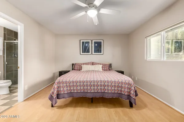 a bedroom with a bed and a window