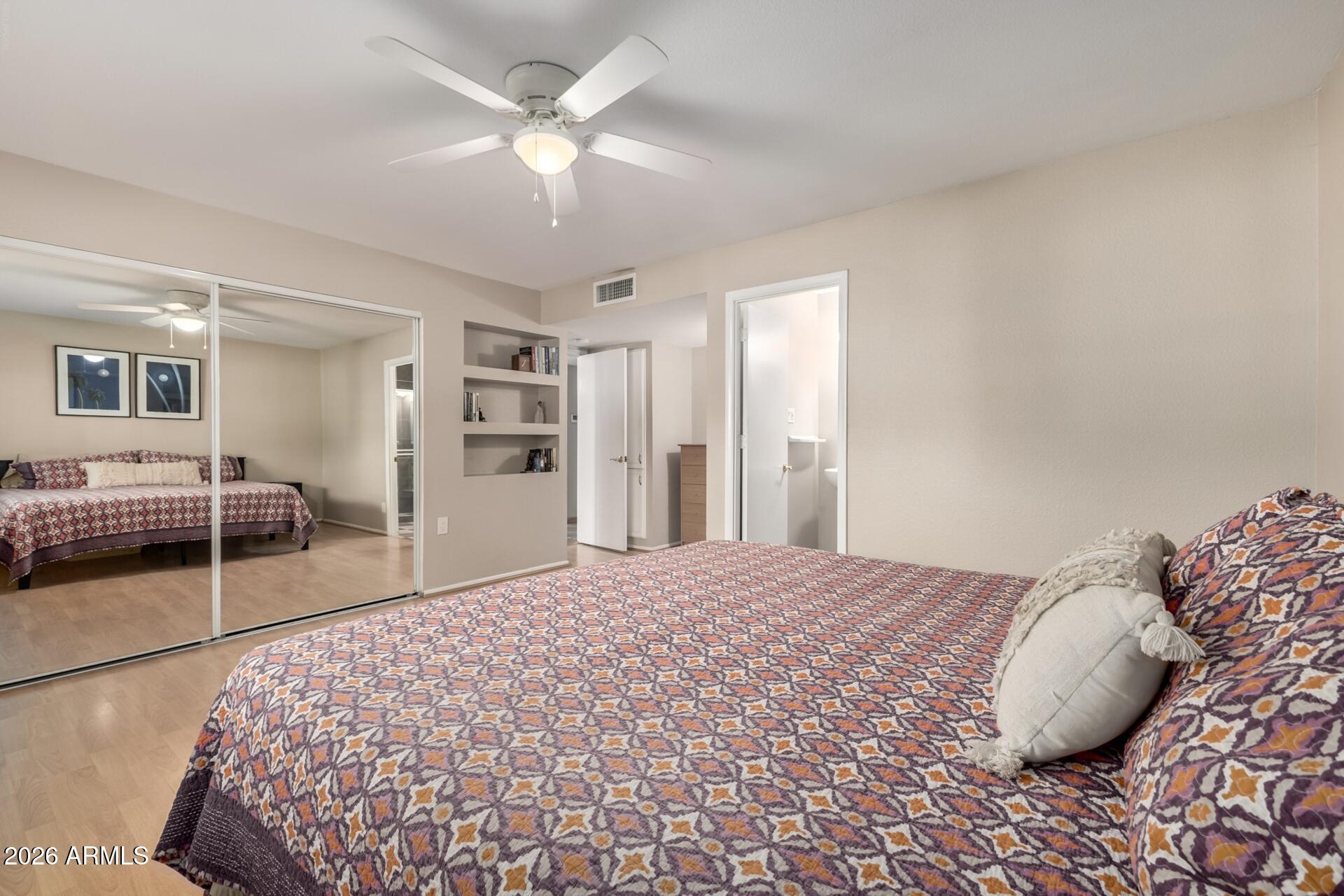 7657 North 22nd Street Phoenix, AZ 85020 - Photo 27 of 76 a bedroom with a large bed and a chandelier