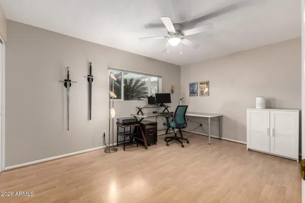 a bedroom with a bed and a chair