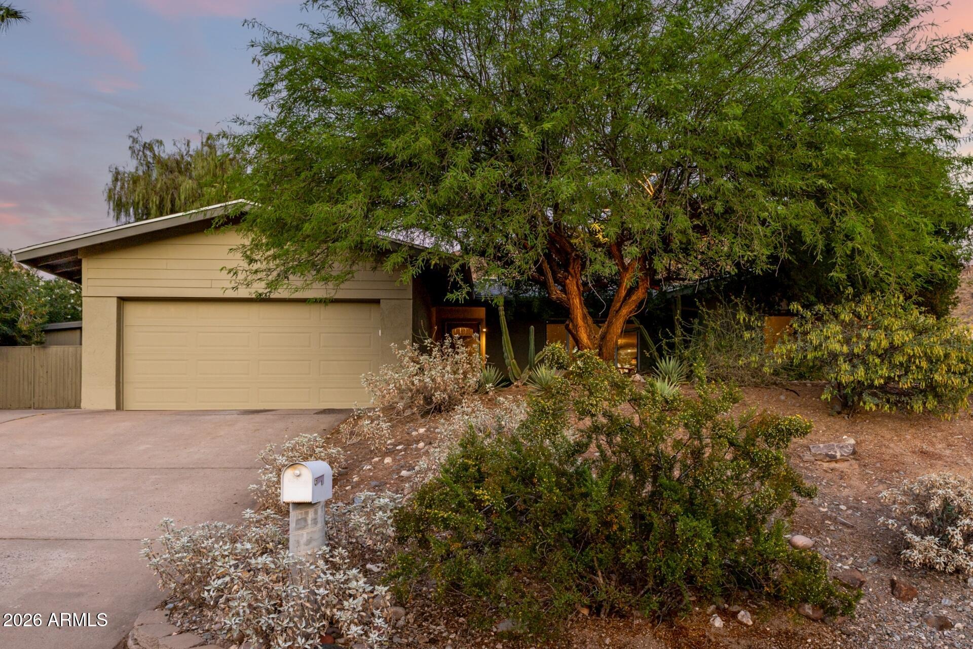 7657 North 22nd Street Phoenix, AZ 85020 - Photo 2 of 76 a front view of a house with a yard and garage