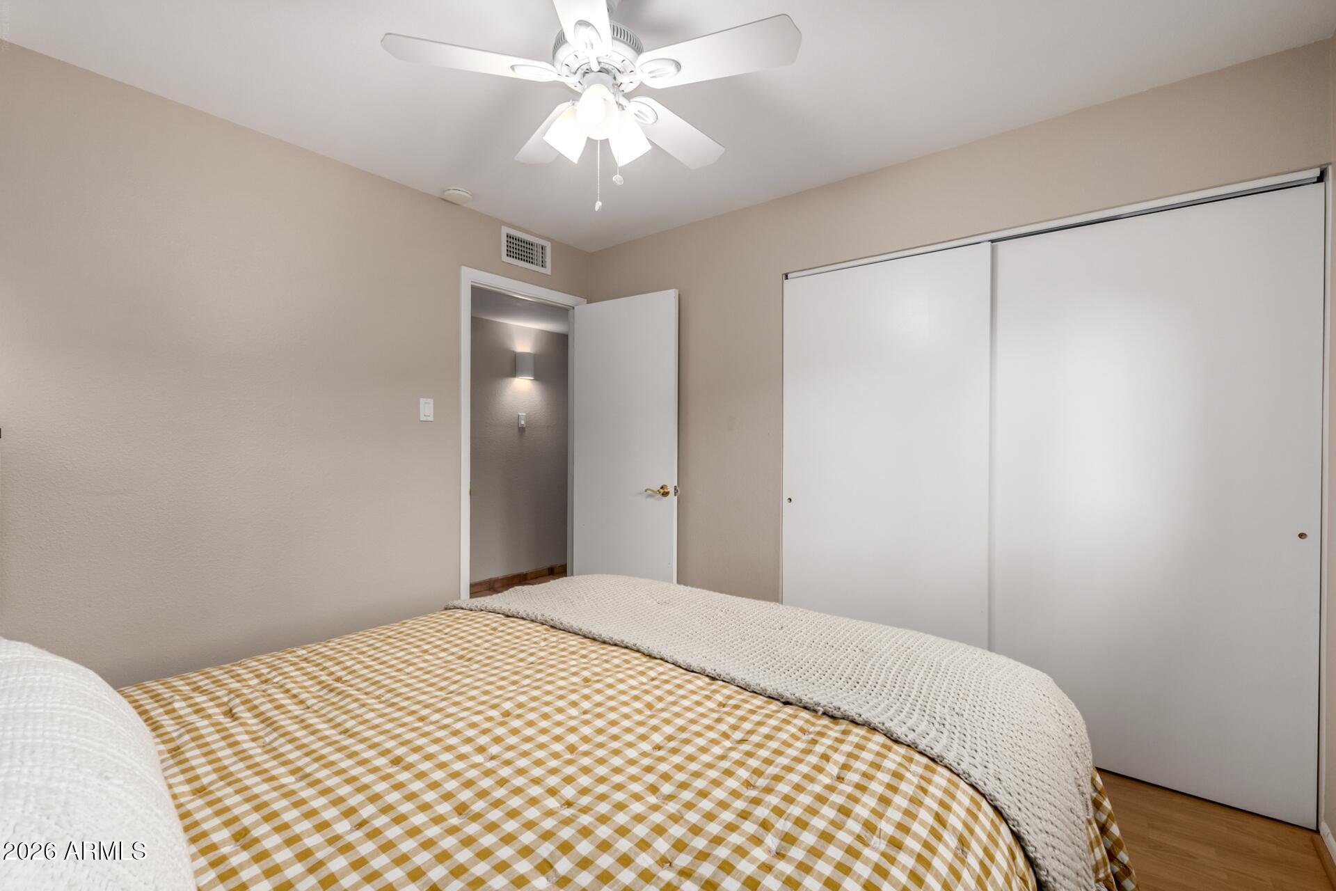 7657 North 22nd Street Phoenix, AZ 85020 - Photo 33 of 76 a bedroom with a large bed and a chandelier
