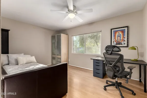 a view of swimming pool with garden and patio