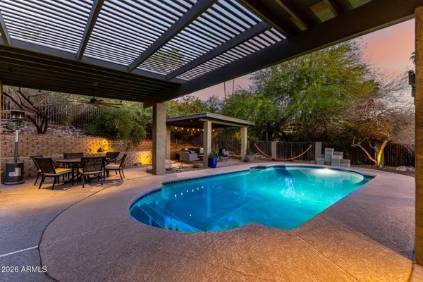 swimming pool view with a seating space
