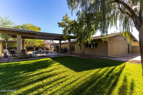 a backyard of a house with a tree