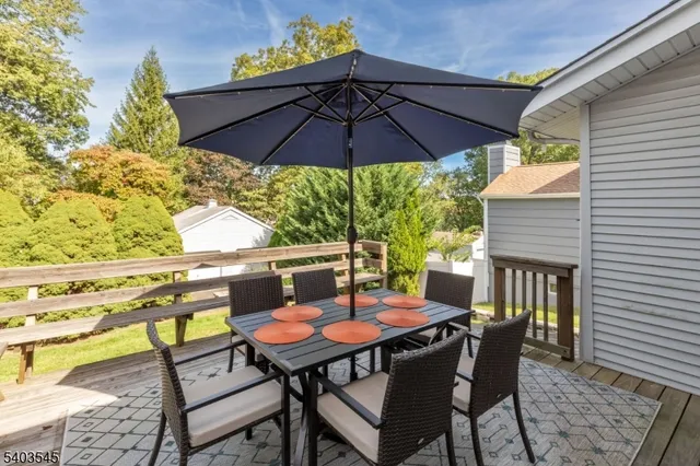 a table and chairs with the umbrella in the patio