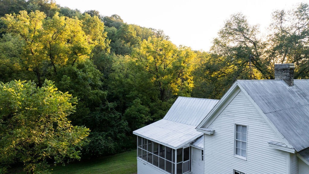 3685 Martin Ervin Road Santa Fe, TN 38482 - Photo 25 of 99 a roof deck with table and chairs under an umbrella