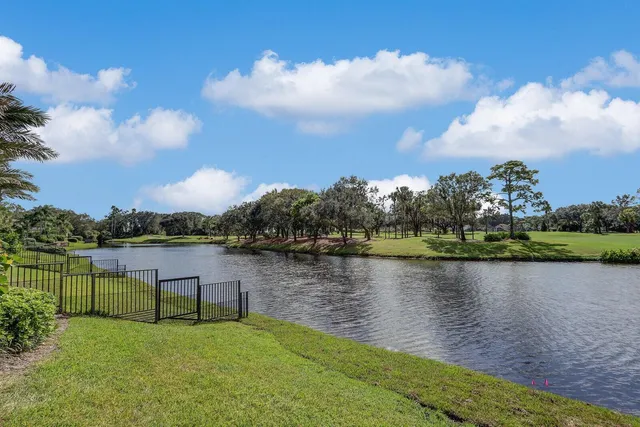 a view of a lake with houses in the back