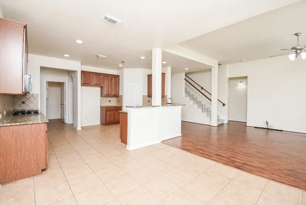 a view of kitchen with refrigerator and cabinets