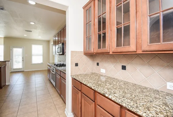 a kitchen with stainless steel appliances granite countertop a refrigerator and a sink