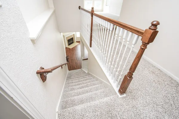a view of a hallway with stairs