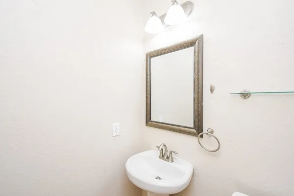 a bathroom with a sink a mirror and vanity