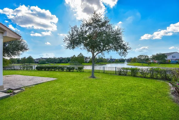 a view of a field of grass and trees