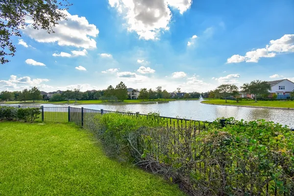 a view of a lake with houses in the back